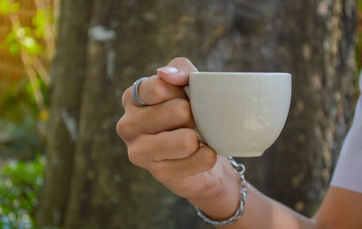 Close-up of woman holding coffee cup