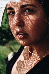 Close-up portrait of young woman looking away