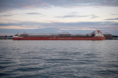 Ship sailing on sea against sky