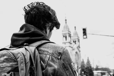 Rear view of man against temple building against sky