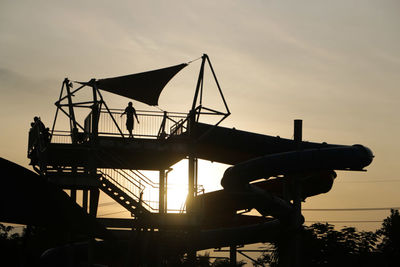 Low angle view of silhouette built structure against sky