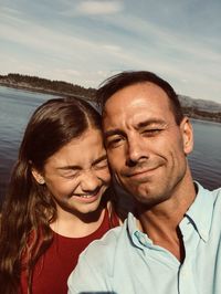 Portrait of young woman against sea