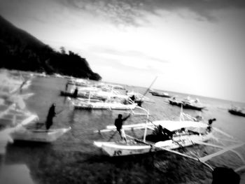 Sailboat on sea shore against sky