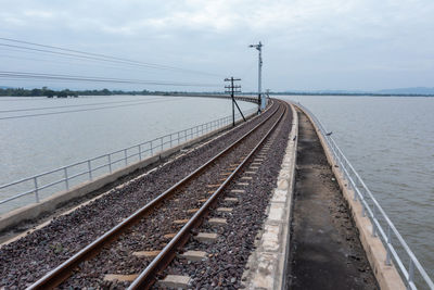 Railway bridge above the reservoir of pa sak jolasid dam at lopburi, amazing thailand in the rain 