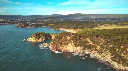 Aerial view of sea and mountains against sky