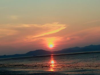 Scenic view of sea against romantic sky at sunset