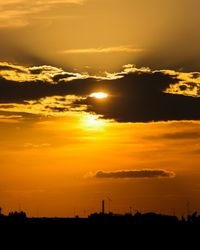 Scenic view of silhouette landscape against romantic sky at sunset