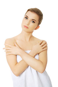 Portrait of woman wrapped in towel against white background