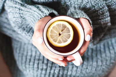 Midsection of woman holding coffee