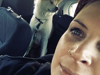 Close-up portrait of young woman in car