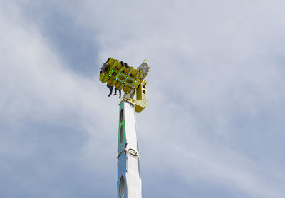 Low angle view of chain swing ride against sky