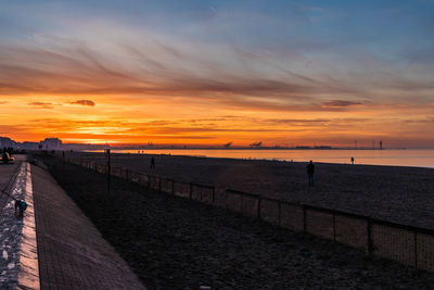 Scenic view of beach against sky during sunset