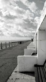 Empty pier over sea against sky