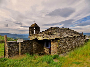 Old building on field against sky