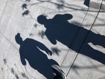 Shadow of people on footpath