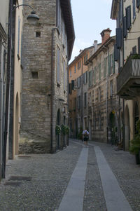 Street amidst buildings in city against sky