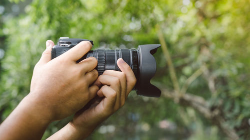 Midsection of person photographing with camera