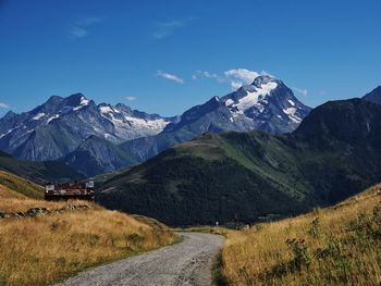 Scenic view of snowcapped mountains against blue sky