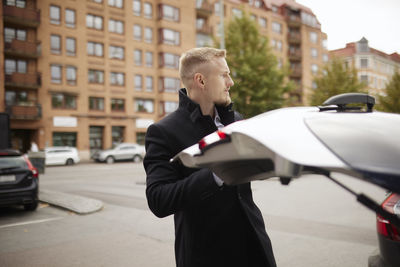 Man opening car trunk