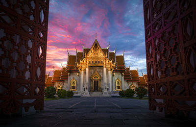 Historic building against sky at sunset