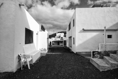 Empty road amidst buildings against sky, tenesar lanzarote