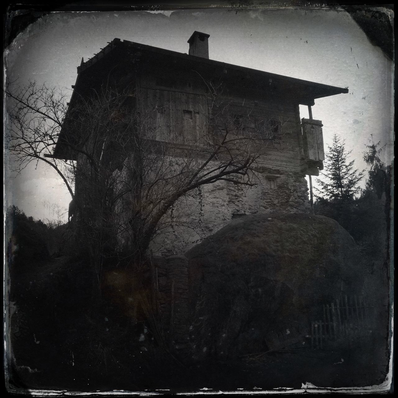 transfer print, building exterior, architecture, built structure, auto post production filter, old, house, sky, wall - building feature, low angle view, outdoors, abandoned, window, building, tree, bare tree, day, weathered, no people, residential structure