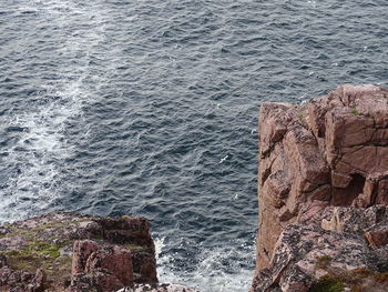 High angle view of rock by sea