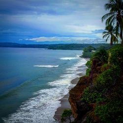 Scenic view of sea against cloudy sky