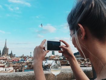 Cropped image of woman holding smart phone