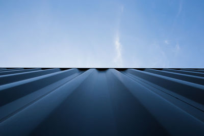 Directly below shot of cargo container against blue sky