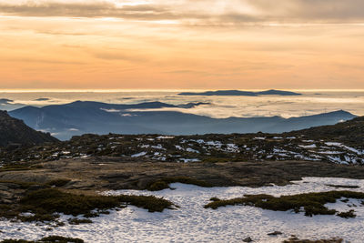 Scenic view of snowcapped mountains against sky during sunset