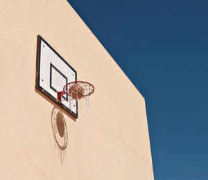 Low angle view of basketball hoop against clear sky