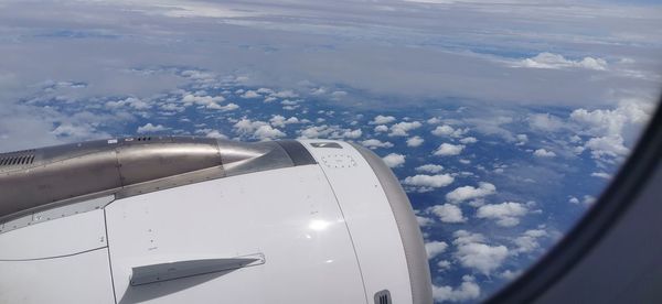 Aerial view of clouds over airplane window