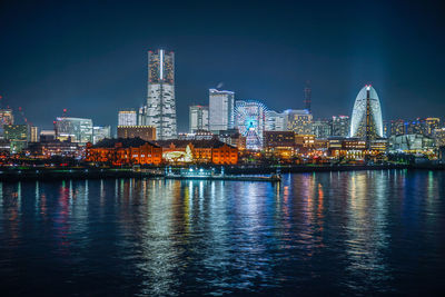 Illuminated city at waterfront