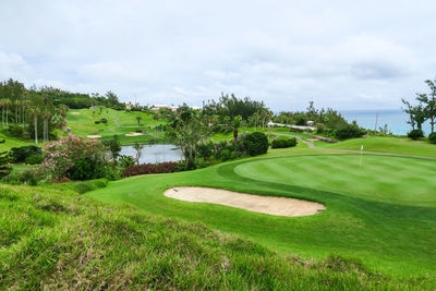 High angle view of golf course against sky