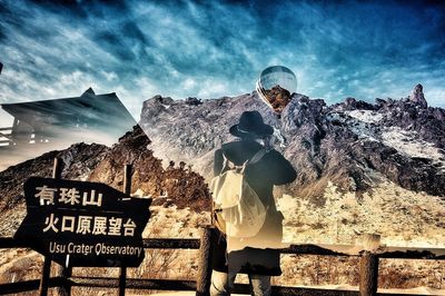 People standing on mountain against sky