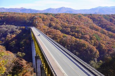 High angle view of road amidst trees against sky