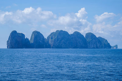 Scenic view of sea and mountains against sky