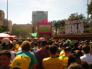 People on street in city against sky