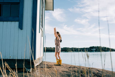 Young girl playing dress up at dancing at the beach on her own