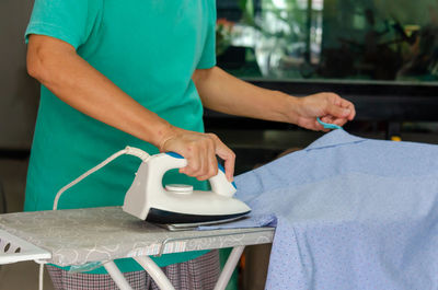 Midsection of man working on table