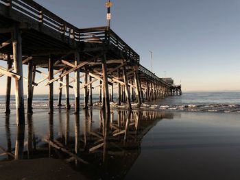 Pier over sea against clear sky