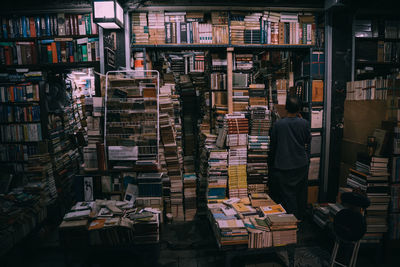 Rear view of man reading book