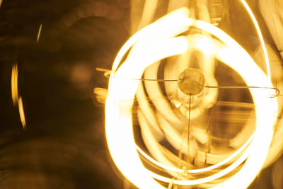 Close-up of illuminated light bulb