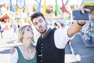 Young man photographing with mobile phone