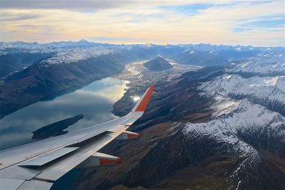 Aerial view of snowcapped mountains against sky