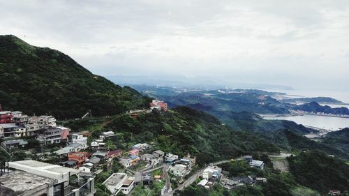 Town on mountain against sky