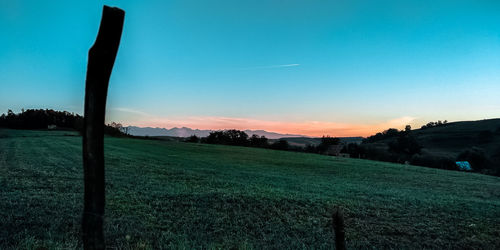 Scenic view of field against sky during sunset