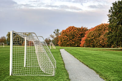 Goal posts on playing field against sky