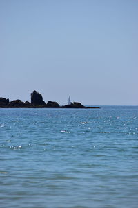 Scenic view of sea against clear blue sky